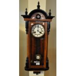 Early 20th Century walnut and ebonised Vienna type two train wall clock with key and pendulum. (B.P.