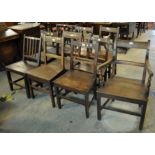 A collection of 19th Century Welsh oak bar and stick back country farmhouse dining chairs, all