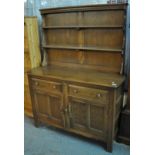 20th Century Ercol elm 'Colonial' dresser with two shelf rack back. With original bill of sale