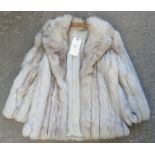 A blue fox fur womens jacket. (B.P. 21% + VAT) No obvious damage. No size label. 44cm shoulder to