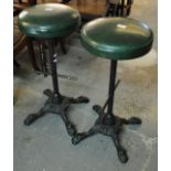 Pair of circular breakfast bar stools with upholstered tops on cast iron quatrefoil bases. (2) (B.P.