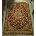 Red ground thick pile fine woven rug with Iranian medallion design. (B.P. 21% + VAT)