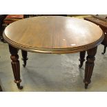 Victorian mahogany circular extending dining table with single extra leaf on baluster turned and