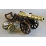 Brass and cast iron cannon on stand, together with a miniature brass cannon on stand. (2) (B.P.