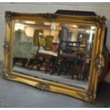 Modern gilt framed bevel plate mirror with beaded and moulded foliate decoration. 91cm wide