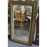 Mid Century pierced and gilt framed mirror of rectangular form with velvet slip. 42 x 74cm