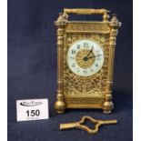 French gilt metal carriage clock in gorge type decorative case with fluted pillars and pierced