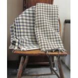 Two antique cream ground check Welsh woollen blankets, one with an indigo check and the other black.