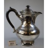 Early 20th Century silver hot water jug of baluster form with ebonised finial and handle and pierced
