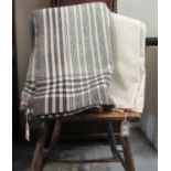 Two Welsh woollen antique narrow loom blankets; one with a black stripe pattern and black, dark