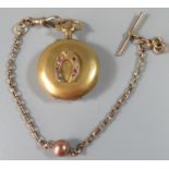 Brushed gold fob watch set to the front with a diamond and ruby set horseshoe. Together with an