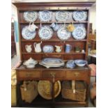 Early 19th Century Welsh oak two stage rack back pot board dresser, the moulded cornice above