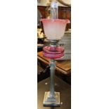 Early 20th century double oil burner having clear glass chimney with art nouveau frilled, pink and
