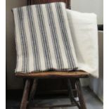 Two antique narrow loom Welsh woollen blankets; one with a wide black striated stripe and the