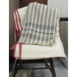 Two antique narrow loom Welsh woollen blankets; one with an indigo stripe and check at the edges and