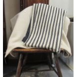 Two antique narrow loom Welsh woollen blankets; one with a narrow black stripe with larger stripe at