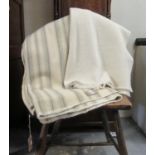 Two antique narrow loom Welsh woollen blankets; one with narrow grey stripes and the other a cream