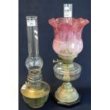 Early 20th Century double oil burner having pink etched frilled shade above a clear glass