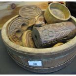 Rustic coopered wooden bowl with metal banding containing various butter moulds and stamps of