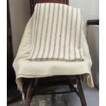 Two antique narrow loom Welsh woollen blankets; one with a narrow brown stripe and the other a plain