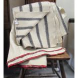 Two antique narrow loom Welsh woollen blankets; one with a wide dark grey stripe and the other a