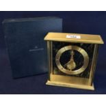 Jaeger Le Coultre gilt metal mantel clock with plain chapter ring and single drum movement. 18cm