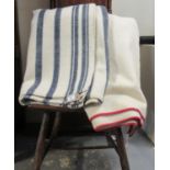 Two antique Welsh woollen narrow loom blankets, one with indigo stripe and the other plain cream