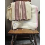 Two antique narrow loom Welsh woollen blankets; one with a narrow dark brown stripe and red and dark