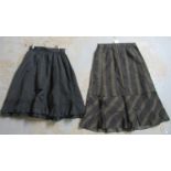 Two late 19th Century black skirts, one a petticoat with ruffled detail to the bottom, the other