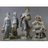 Four Lladro Spanish porcelain figurines of young boys and girls, one with pails and another with a