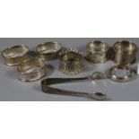 Bag containing five silver napkins rings, silver plated sugar nips, etc. 2.7 troy oz