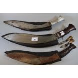 Three kukri knives with leather scabbards. (3) (B.P. 21% + VAT)