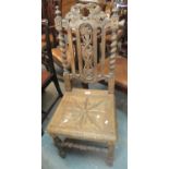 Late Victorian carved oak hall chair with pierced foliate decoration on barley twist supports. (B.P.