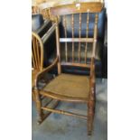 20th Century beech spindle back rocking armchair on cane seat. (B.P. 21% + VAT)