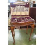 The King Charles canteen of silver plated cutlery in walnut serpentine case on cabriole legs. (B.