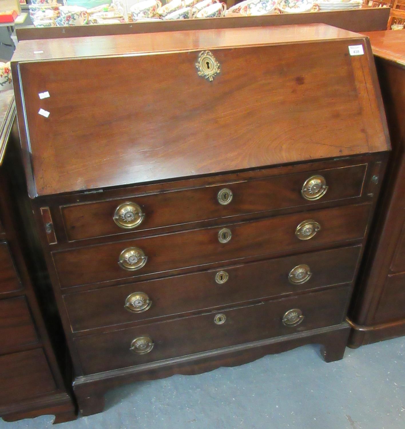 19th Century mahogany fall front bureau with fitted interior above a bank of four drawers on bracket