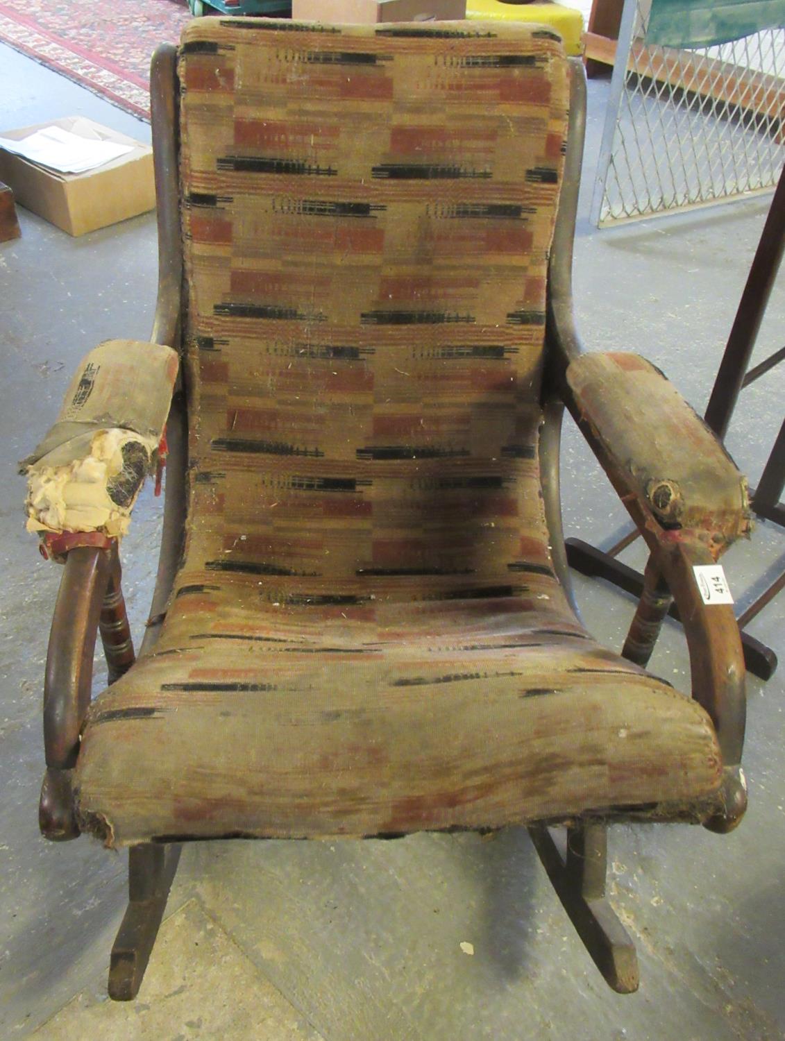 Victorian mahogany upholstered rocking armchair in distressed condition. (B.P. 21% + VAT)