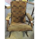 Victorian mahogany upholstered rocking armchair in distressed condition. (B.P. 21% + VAT)