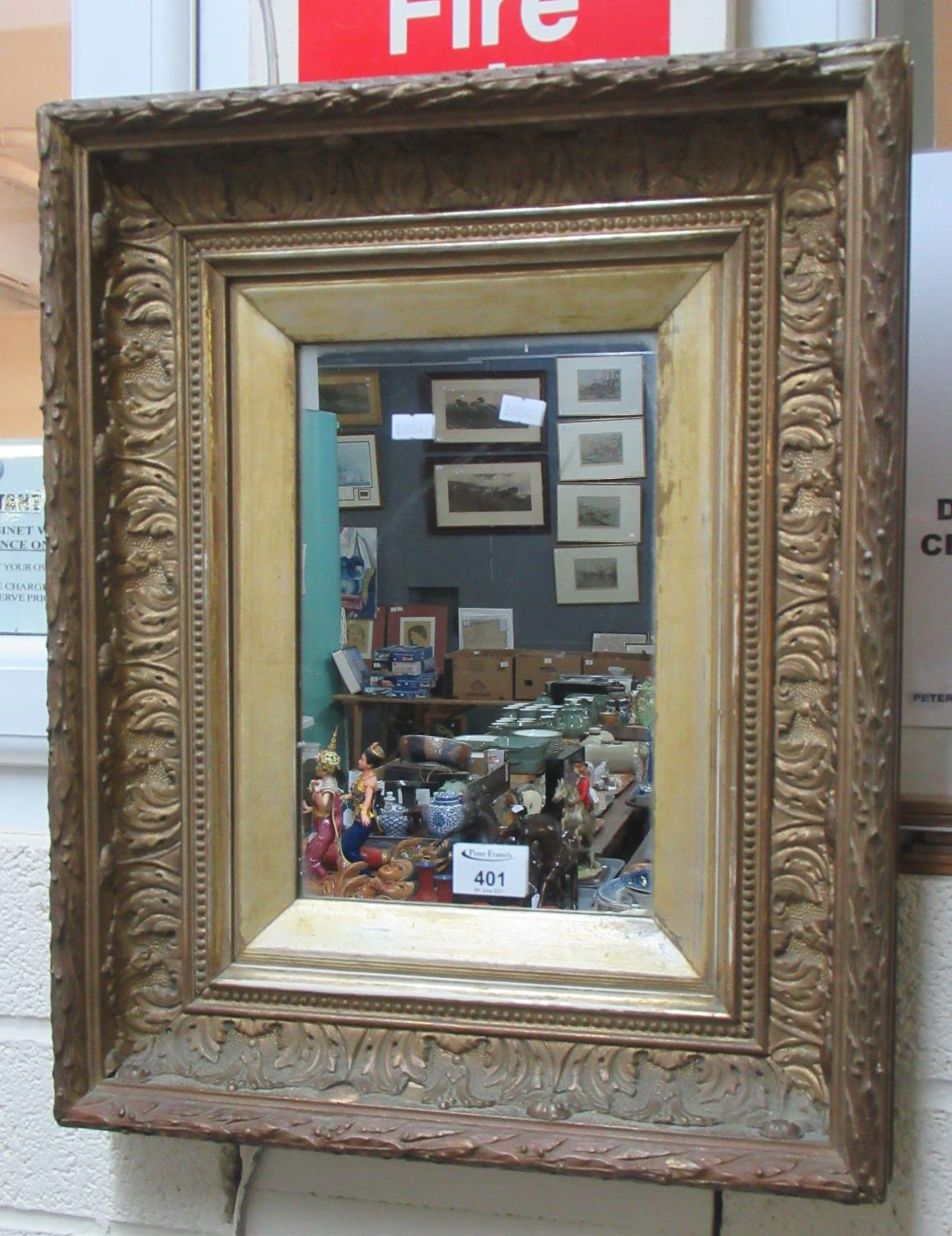 Small rectangular gilt framed mirror with moulded foliate frame and gilt slip. (B.P. 21% + VAT)