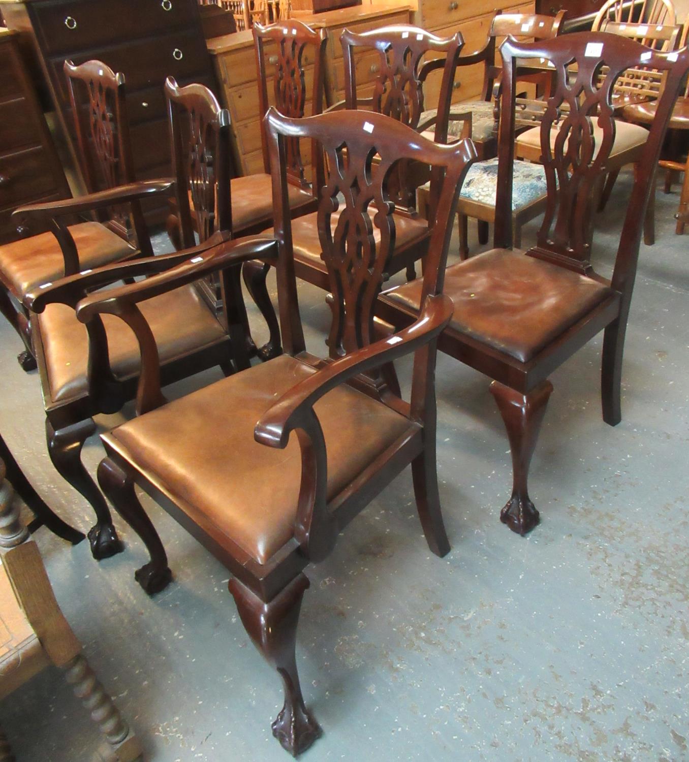 A set of six mahogany Chippendale style dining chairs with leather drop in seats, standing on