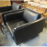 Pair of modern brown leather deep back armchairs on tubular supports. (2) (B.P. 21% + VAT)