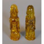 A pair of simulated amber carved figural phalli, modern. (2) (B.P. 21% + VAT)