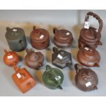 Collection of eleven Chinese Yixing pottery style teapots of varying forms, melon shaped etc. (