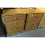 A pair of modern pine straight front chests of four drawers with turned handles on a projecting