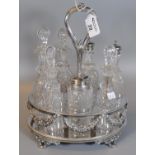 Silver plated and glass seven piece cruet set on oval stand with scroll feet and swag decoration. (