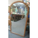 Two modern mirrors, one with an oak frame and dome top, the other painted of rectangular form. (