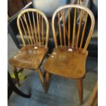 A pair of elm spindle back kitchen chairs, impressed marks to one chair C Gibbons Wickham 1895. (