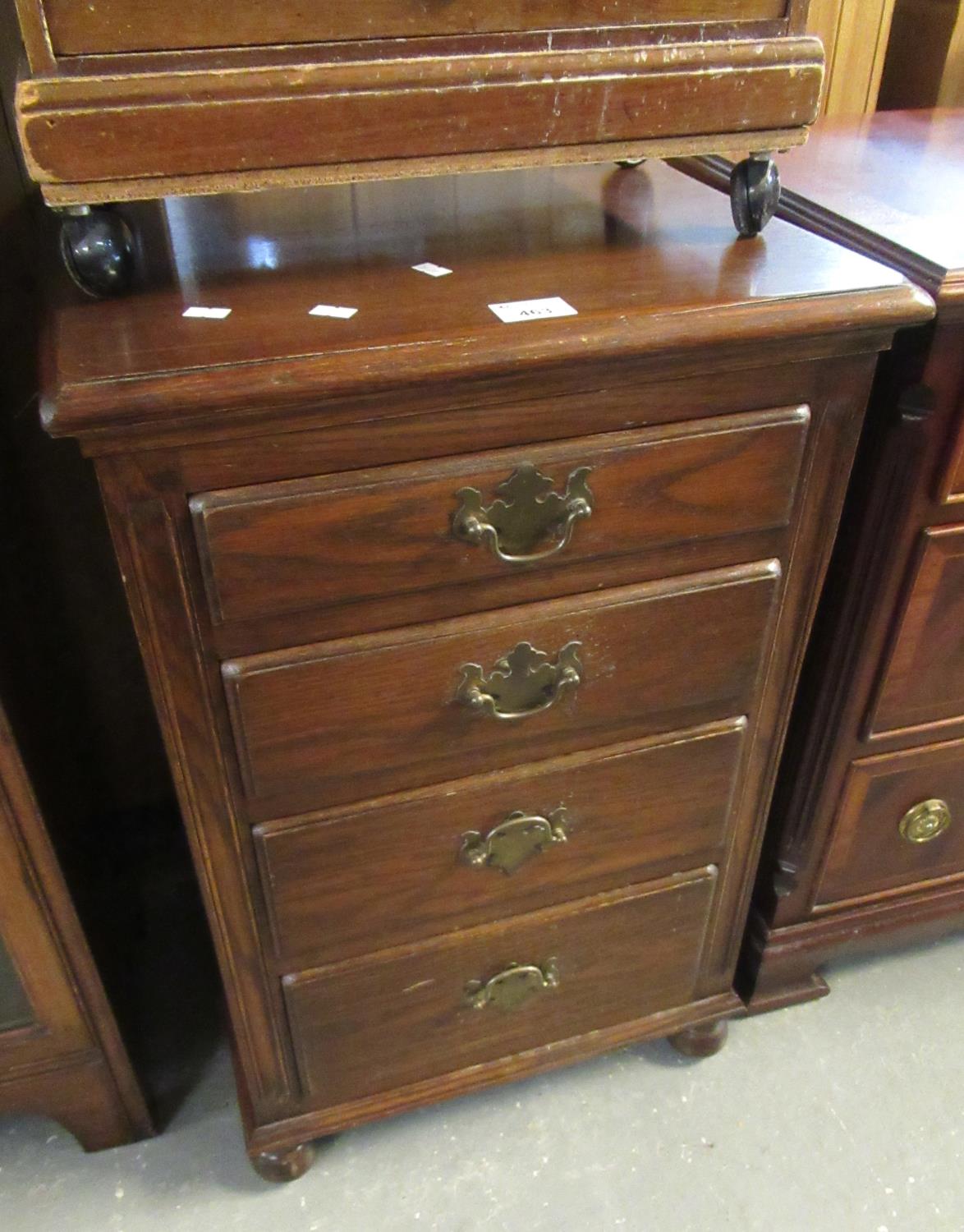 Reproduction mahogany straight front chest of four drawers of narrow proportions on bun feet. (B.