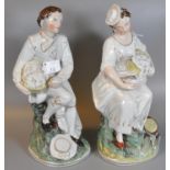 Two early 20th Century continental figurines, one with a basket, the other holding a bird, unmarked.