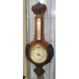 Early 20th Century carved oak aneroid barometer. (B.P. 21% + VAT)